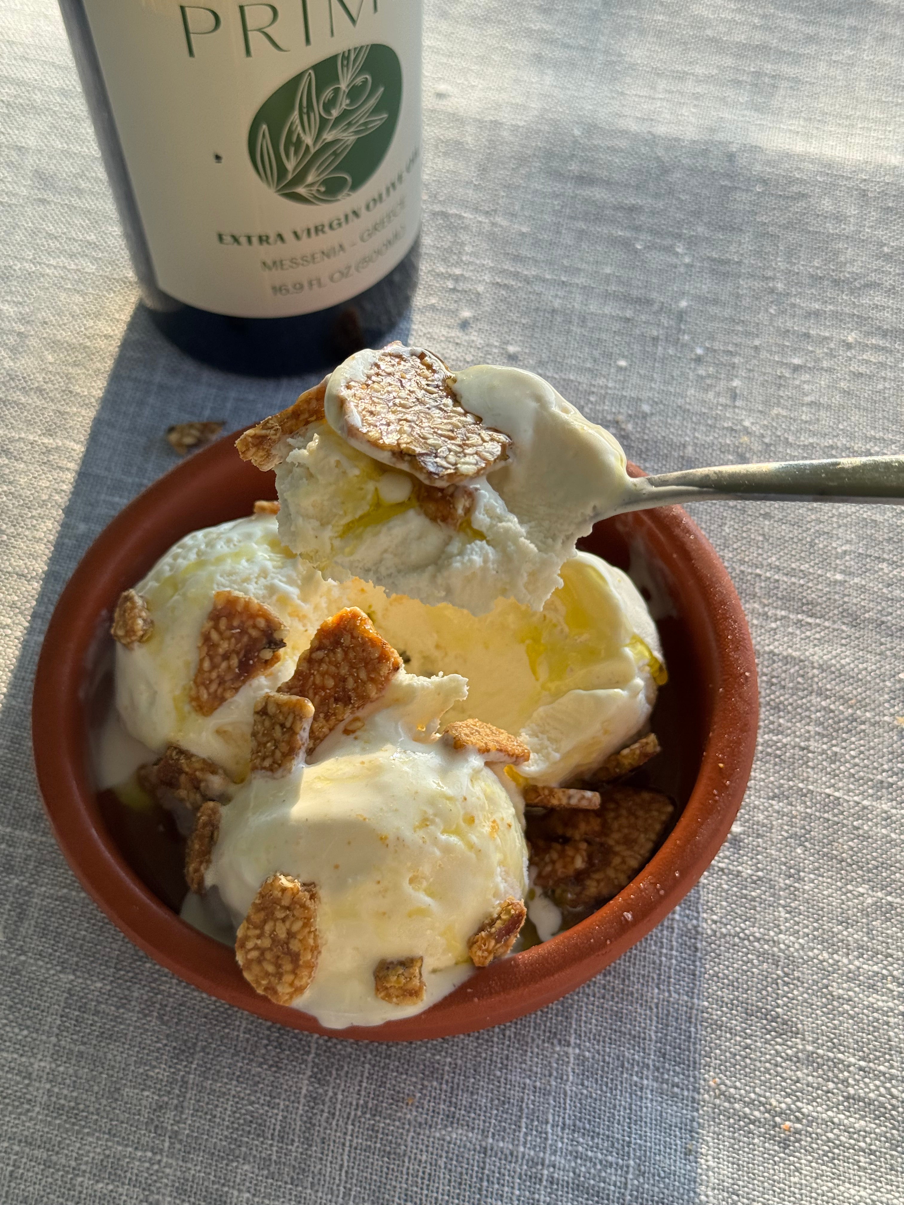 Greek sundae with vanilla ice cream, early harvest olive oil drizzle, flaky sea salt, and crushed pistachio Pasteli